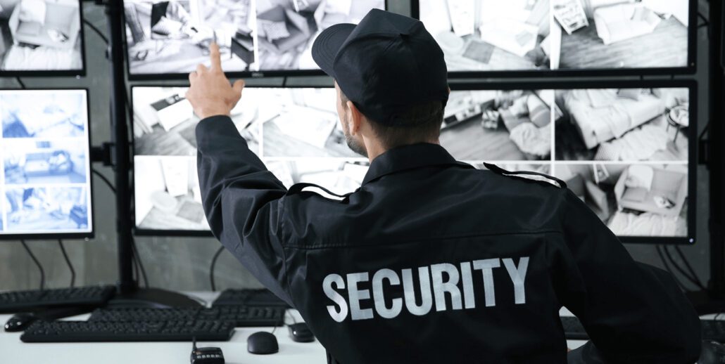 security guard analysing security screens.